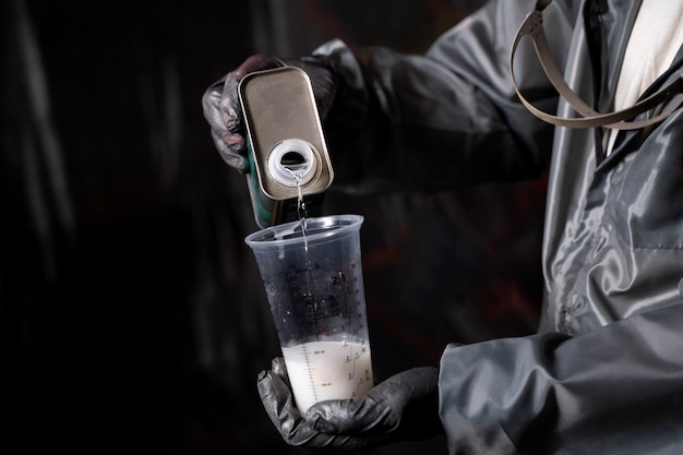 High angle worker pouring paint