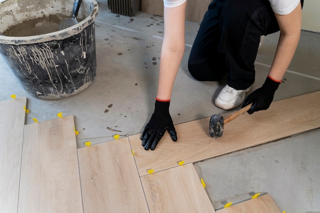 Free Photo high angle worker tiling floor