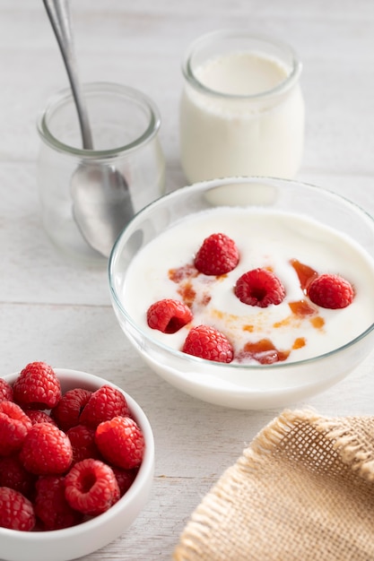 High angle  yogurt with raspberries