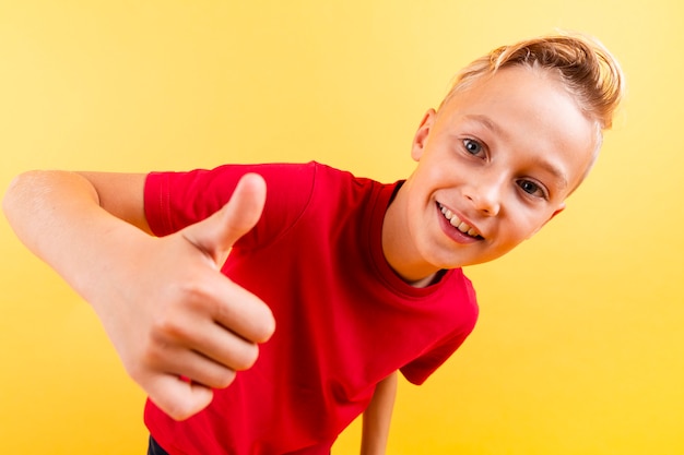 High angle young boy showing ok sign