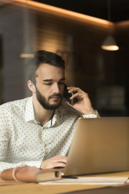 High angle young entrepreneur talking over phone