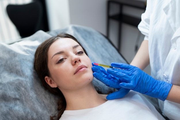 Free photo high angle young woman getting prp injection