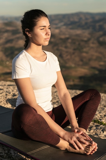 Free photo high angle young woman meditating