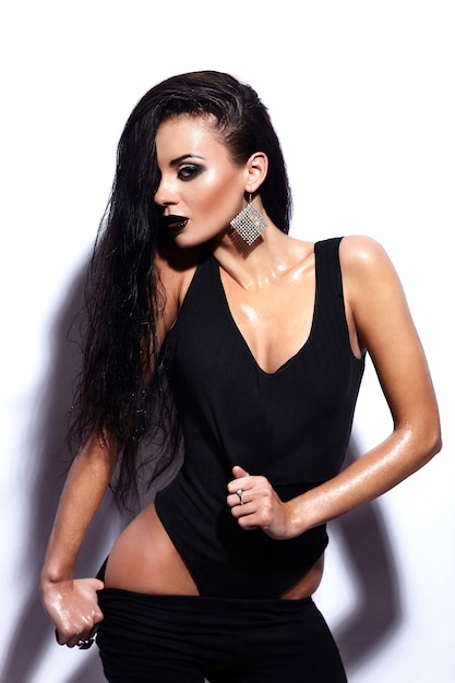 Free photo high fashion look.glamor portrait of beautiful sexy stylish brunette caucasian young woman model with black lips,bright makeup, with perfect clean wet skin in black cloth