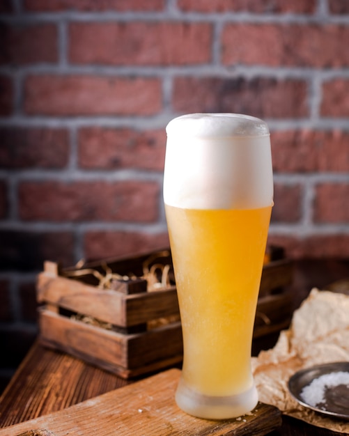 High glass of beer with foam