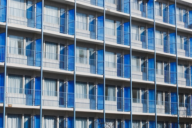 High hotel building with balconies with metal fences