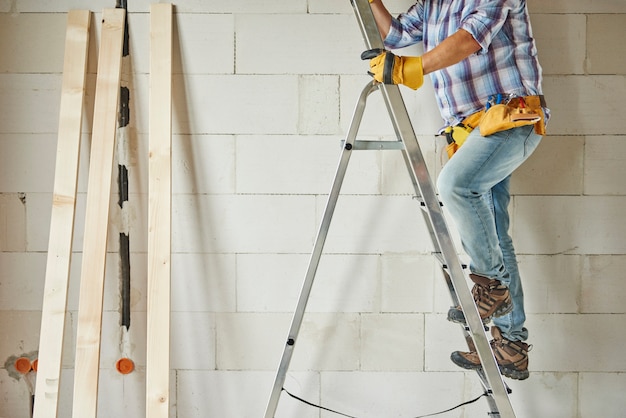 Free Photo high ladder as a support for carpenter worker