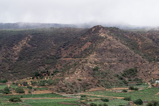 Free photo high mountain peak in the clouds