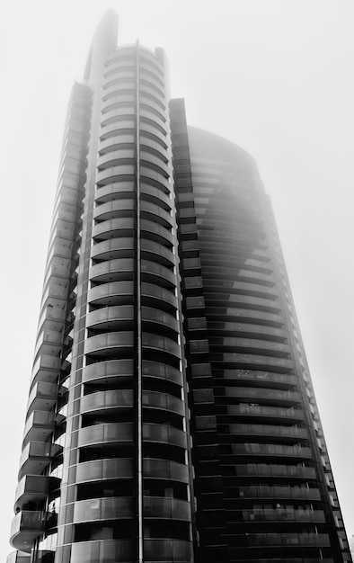 Free photo high-rise building with glass windows under sunlight