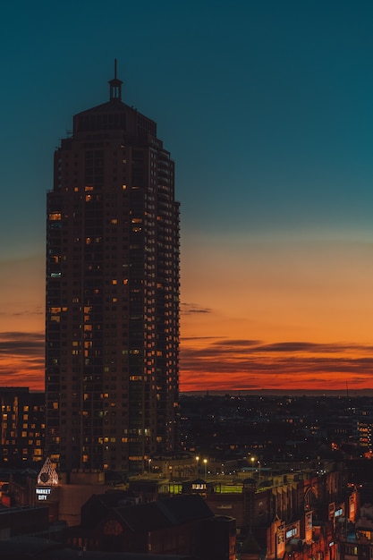 high rise building with an orange and blue sky