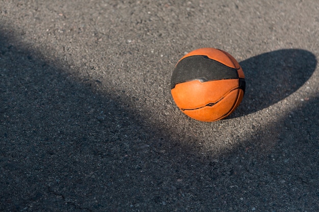 Free photo high view basketball on asphalt