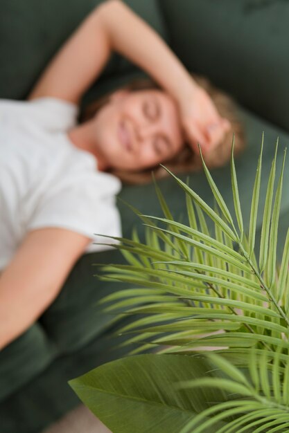 Free photo high view blurred woman sitting on a couch