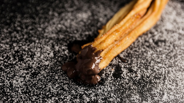 High view churros dipped in chocolate