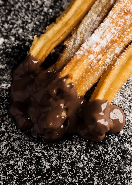 Free photo high view churros with sugar and chocolate