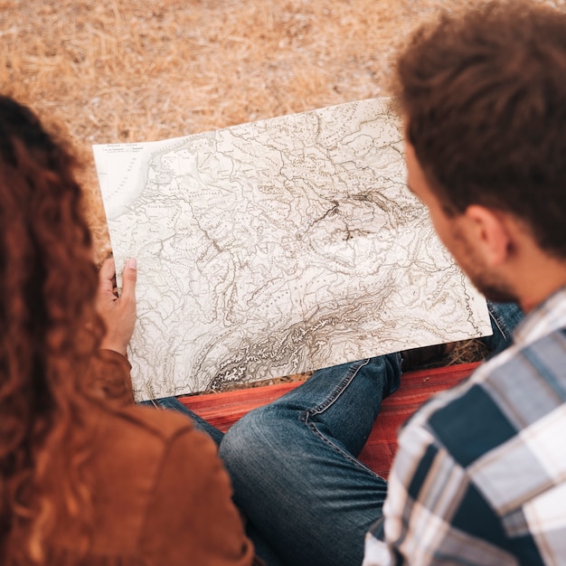 Free Photo high view couple looking on a map