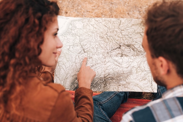 Free photo high view couple looking on a map