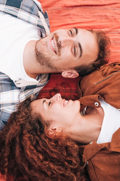 High view couple lying on blanket