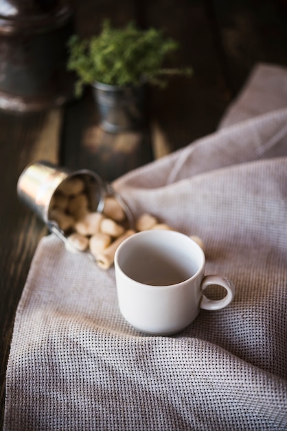 High view cup of coffee and sugar on burlap fabric