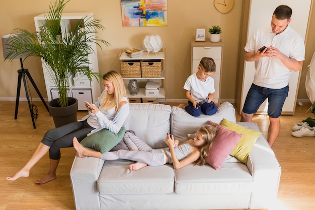 High view family spending their time on mobile phone