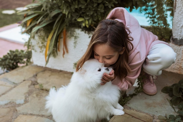 Free photo high view girl kissing her dog