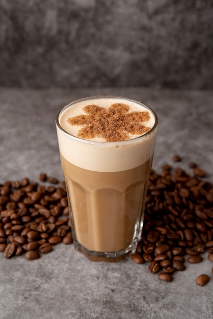 High view glass of cappucino with coffee beans