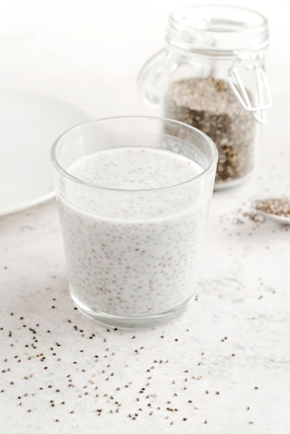 High view glass of milk and seeds