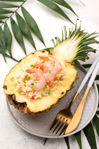 High view half of pineapple with seafood