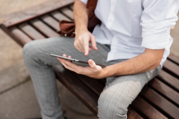 High view man in white shirt working on tablet