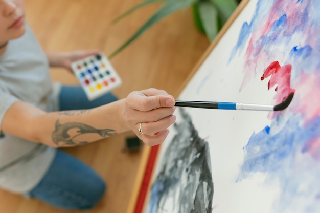 Free photo high view person creating a painting