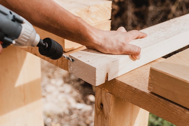 Free photo high view person holding a hammer drill