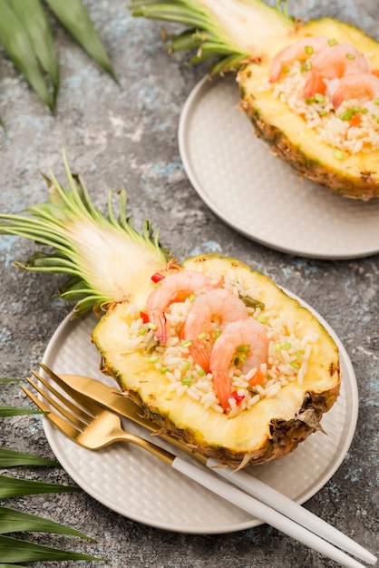 High view pineapple on plate with cutlery