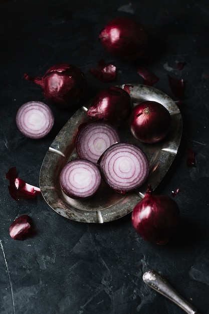 Free photo high view red onions on a plate and knife