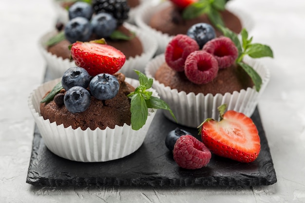 Free photo high view tasty cupcake with forest fruit and strawberries