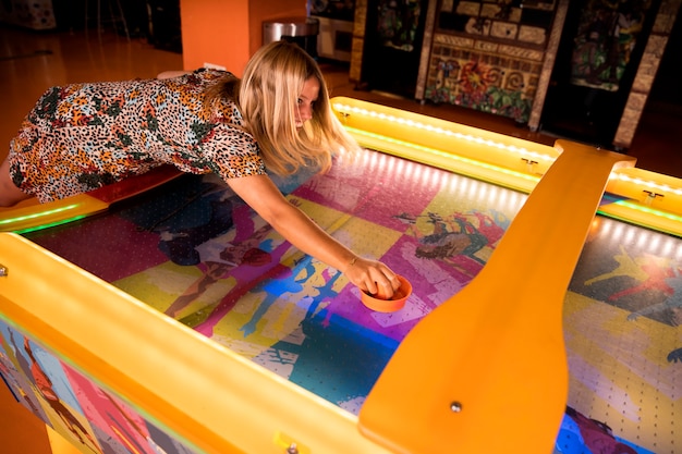 Free Photo high view woman playing air hockey