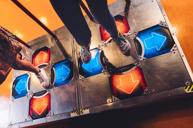 High view women playing dancing arcade