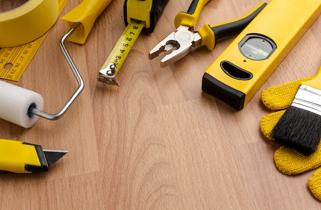 High view yellow repair tools on wooden background