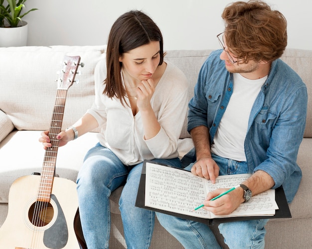 High view young female student learning guitar