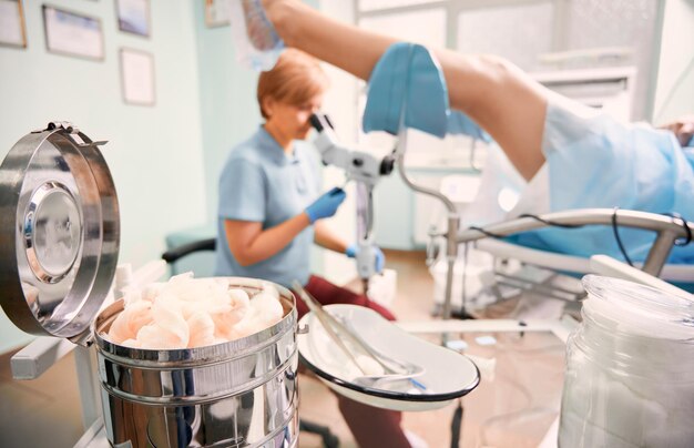 Highly qualified doctor examining woman with colposcope