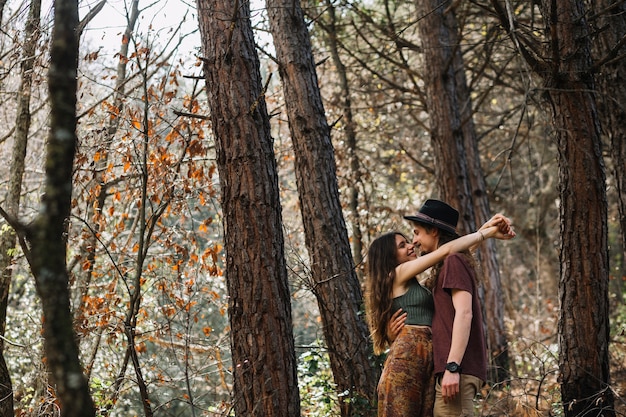 Free photo hiker couple in love kissing in nature