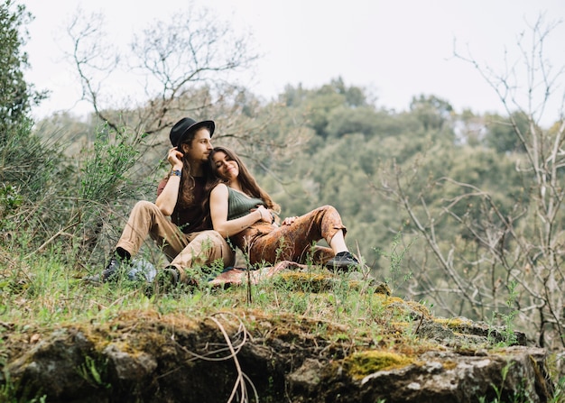 Free photo hiker couple in love sitting in nature