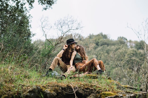 Hiker couple in love sitting in nature