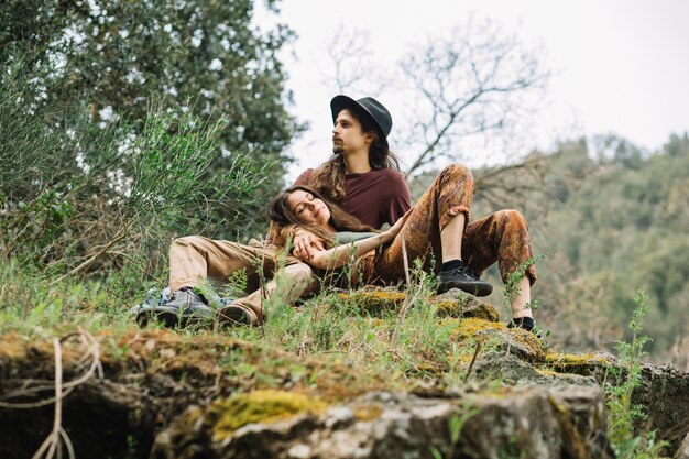 Hiker couple in love sitting in nature