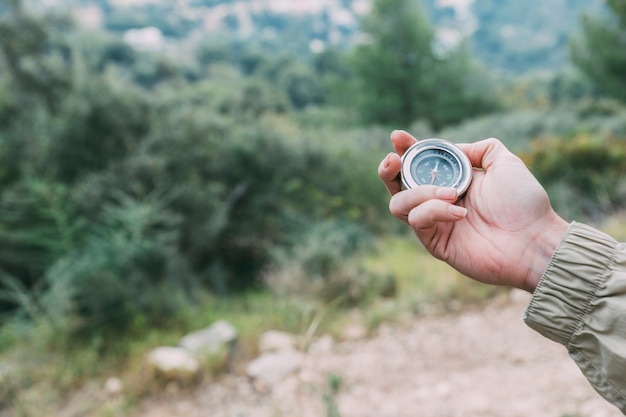 Free photo hiker holding compass