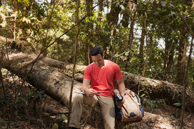 Hiker reading booklet