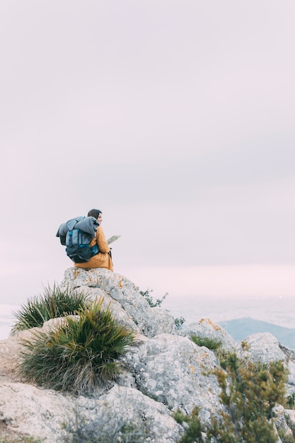 Free Photo hiker sitting on rocks