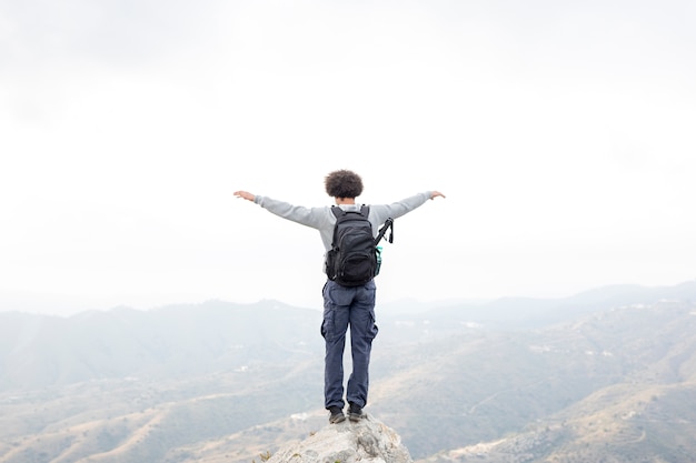 Free photo hiker standing on rock