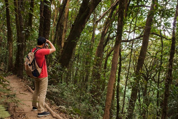 Hiker with backpack taking a photo