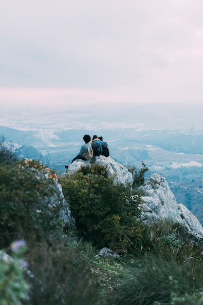 Free Photo hikers sitting on rock