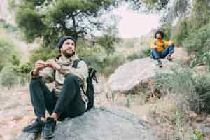 Free photo hikers sitting on rock