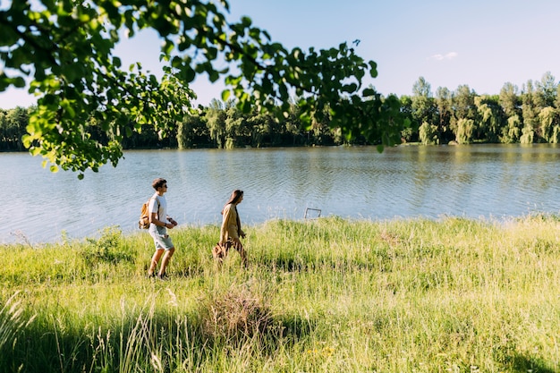 Hiking couple walking near the lake